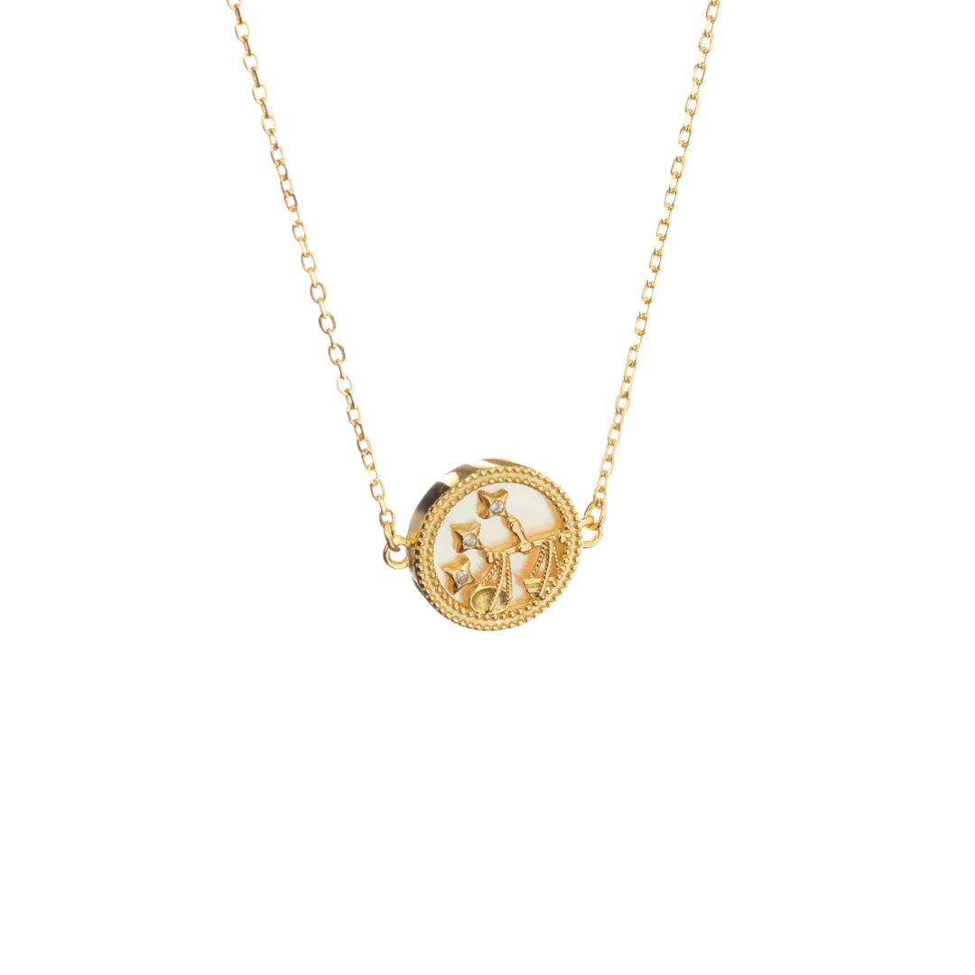 Gold Libra necklace with scales and subtle stars, reflecting balance, beauty, and harmony.