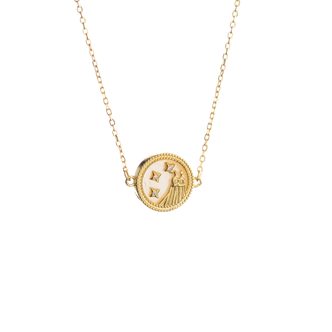 Gold Gemini necklace featuring twin-inspired design and stars, reflecting duality and curiosity.