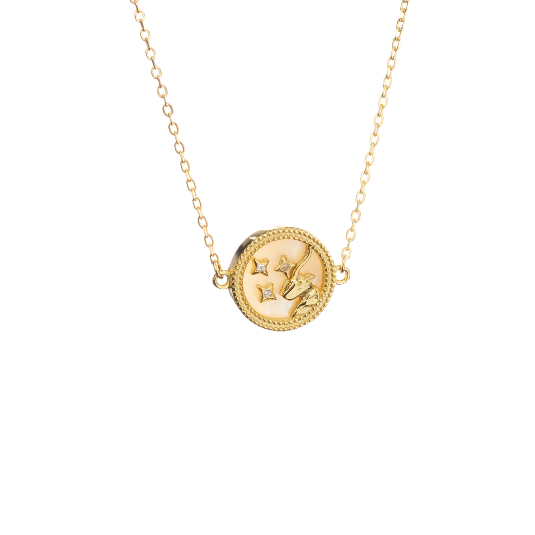Gold Capricorn necklace with goat engraving and celestial touches, honoring ambition and focus.