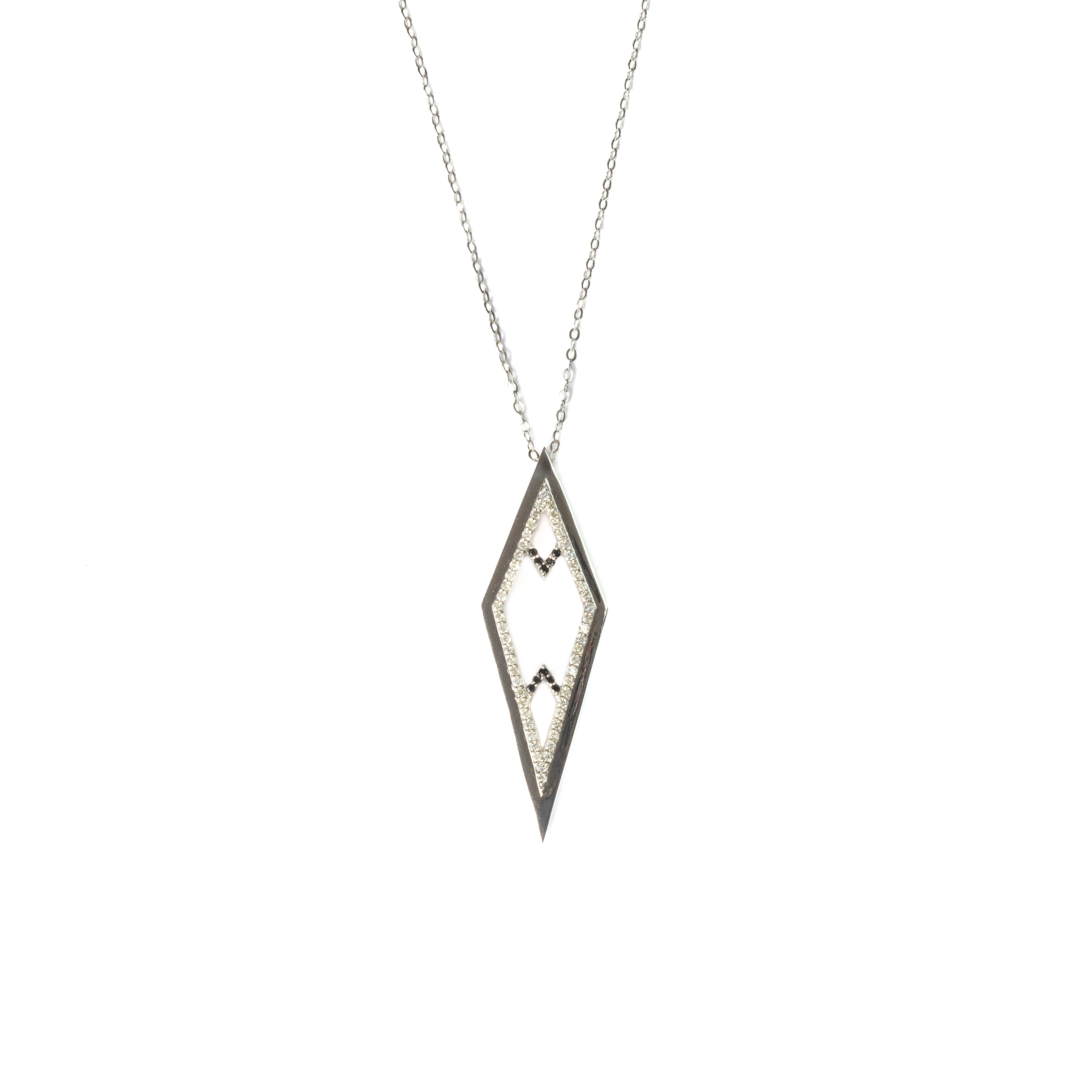 An elegant gold necklace showcasing a refined geometric pendant, intricately set with black stones and white diamonds — a bold yet graceful piece embodying contemporary Arabian sophistication.