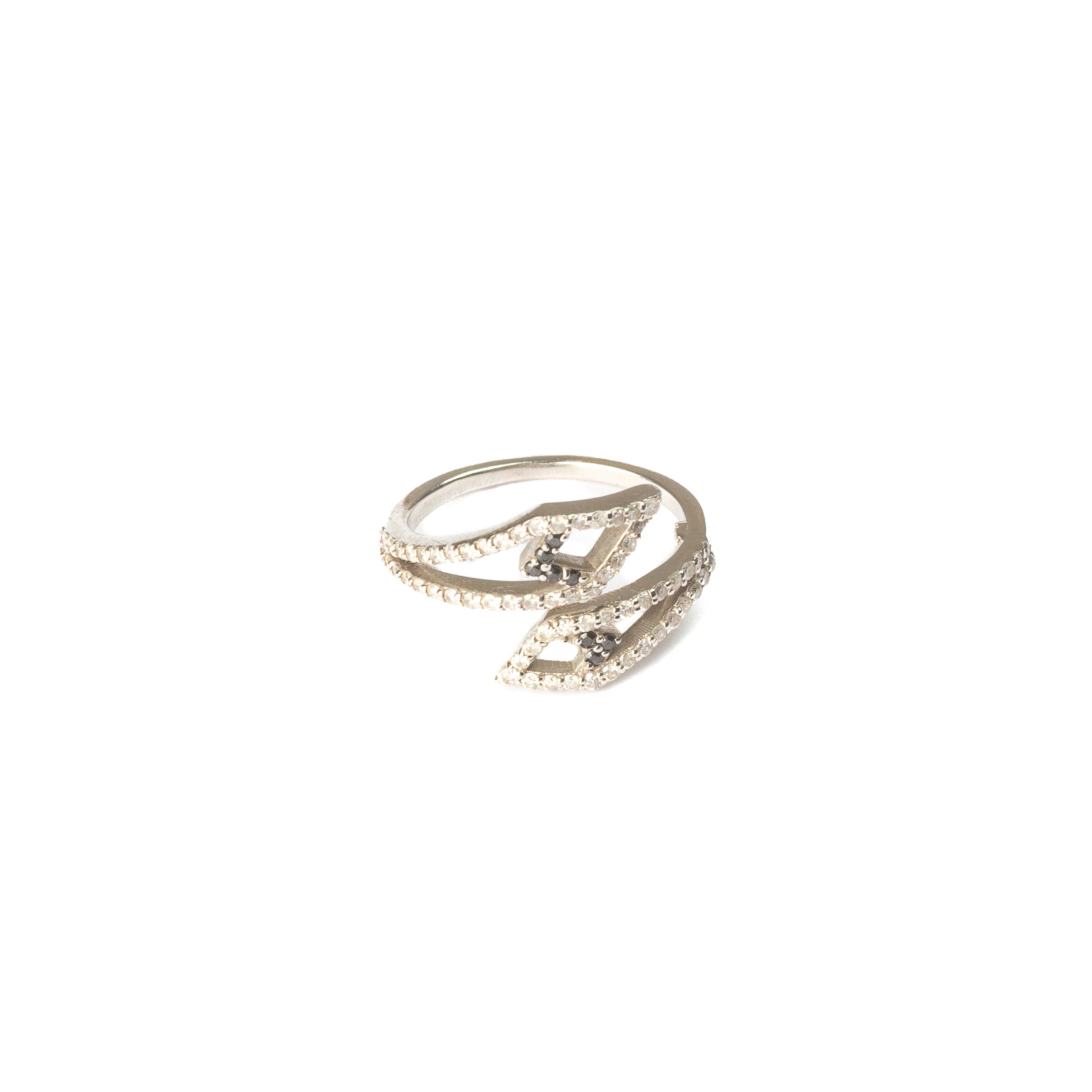 White gold Sadu ring featuring geometric lines adorned with white and black stones and diamonds, displayed on a white background.