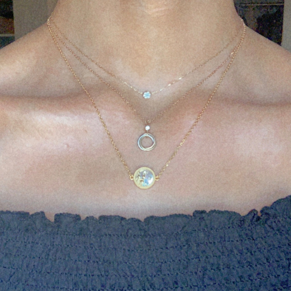Layered look featuring the Zodiac necklace styled with delicate chains — a radiant expression of personality and elegance.